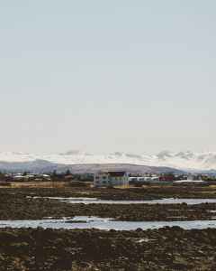 trapped water on the ground with buildings at distance